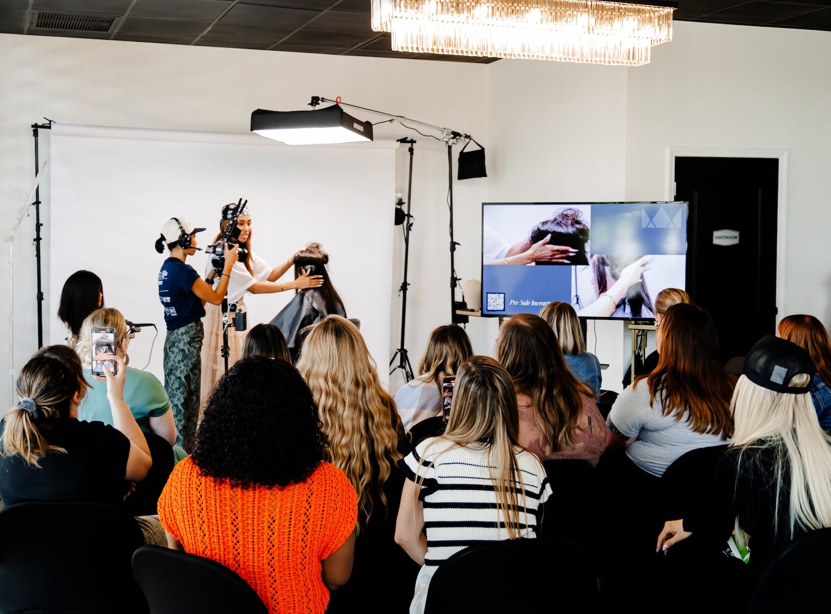 Candice Motley demonstrates luxury hair replacement techniques during a Confidence with Crowns class