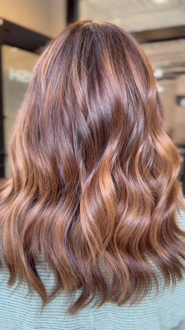 a Garnish guest with rich brunette extensions highlighted with pumpkin spice
